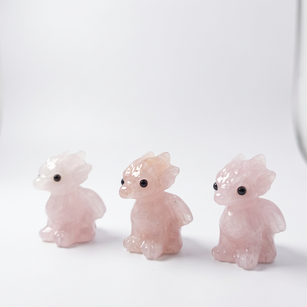 Natural Rose Quartz Dragon Carvings on pure white background