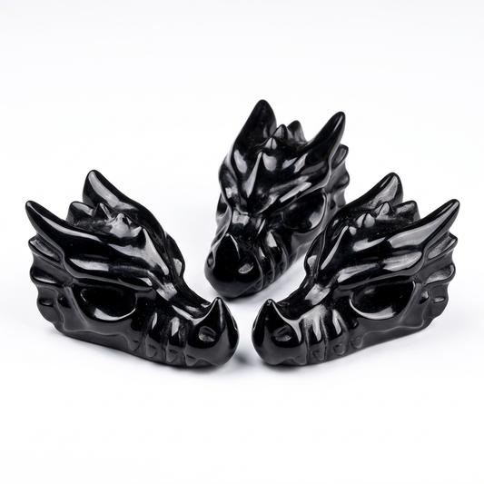 Three Natural Black Obsidian Dragon Head Carvings on pure white background