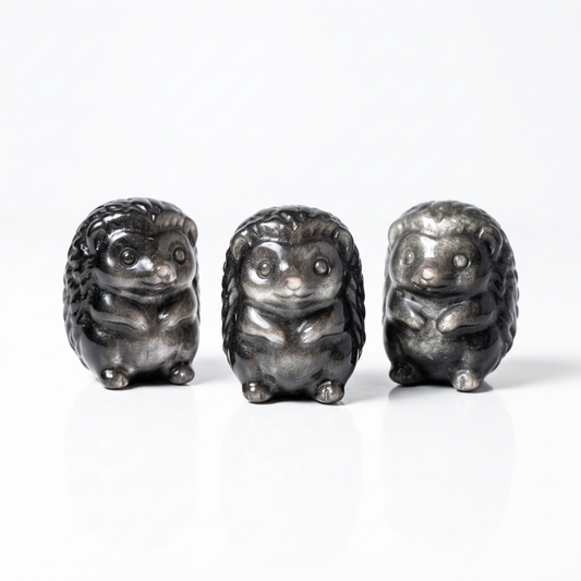 Three Silver Sheen Obsidian Hedgehog Carvings on pure white background